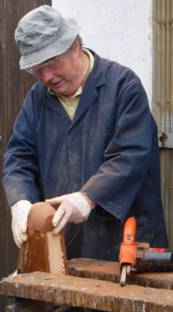 griff making partially completed hardwood monkey clamped in a workbench