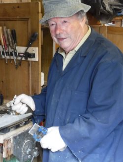 griff sharpening plane blade at workbench